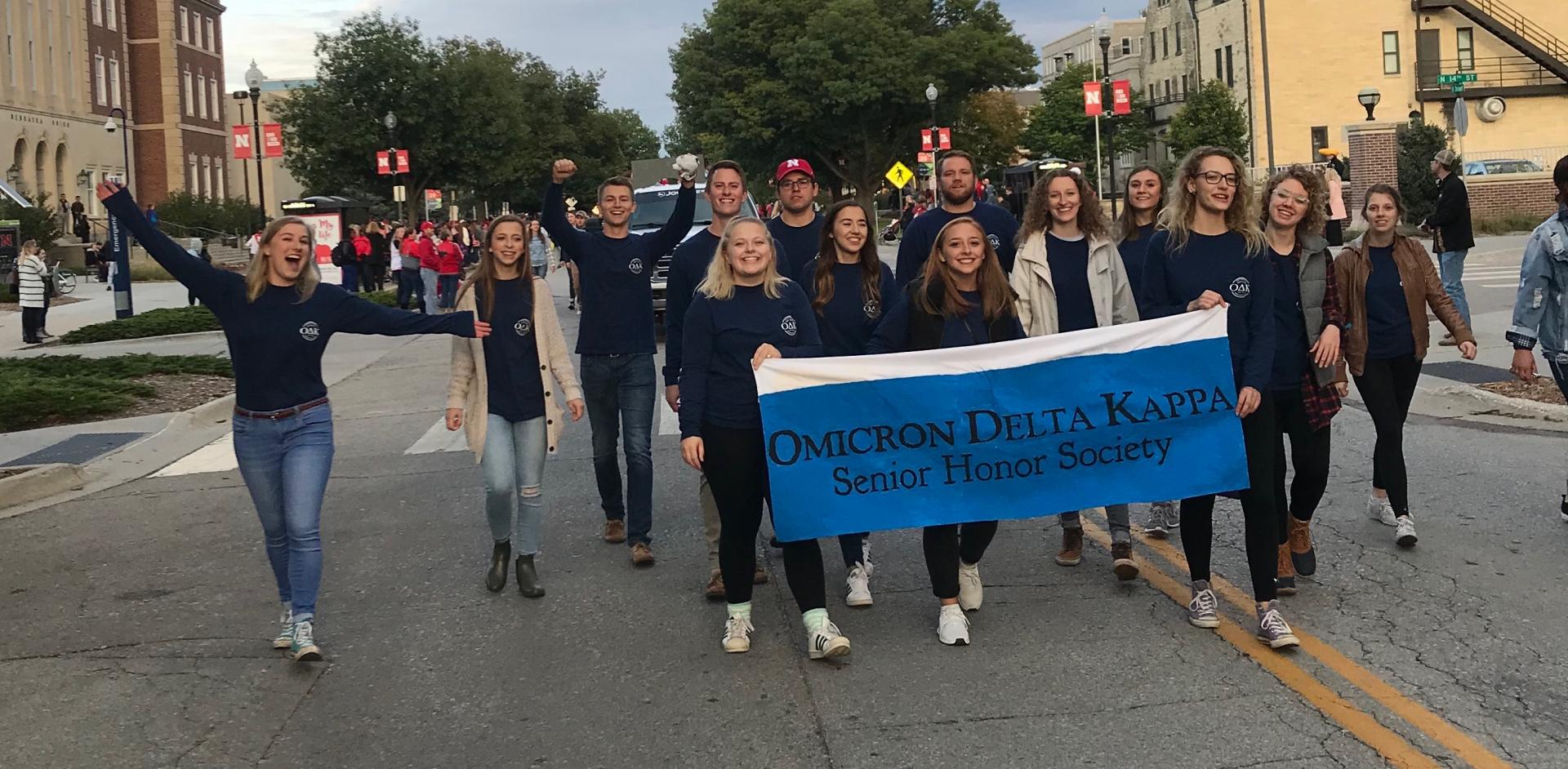 Members of O D K carrying a banner in a parade